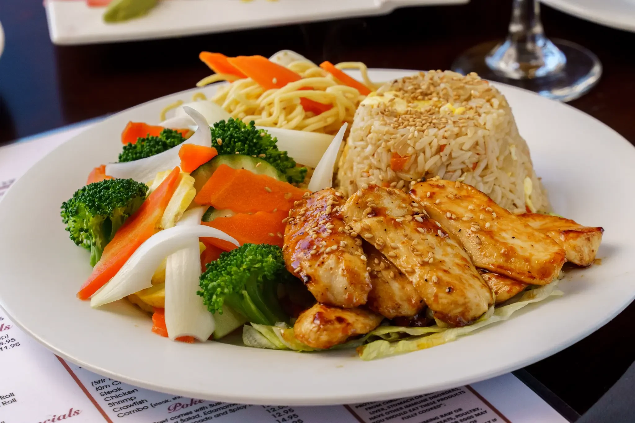 Hibachi Chicken - Tender grilled chicken cooked on the hibachi, served with fried rice and fresh vegetables.